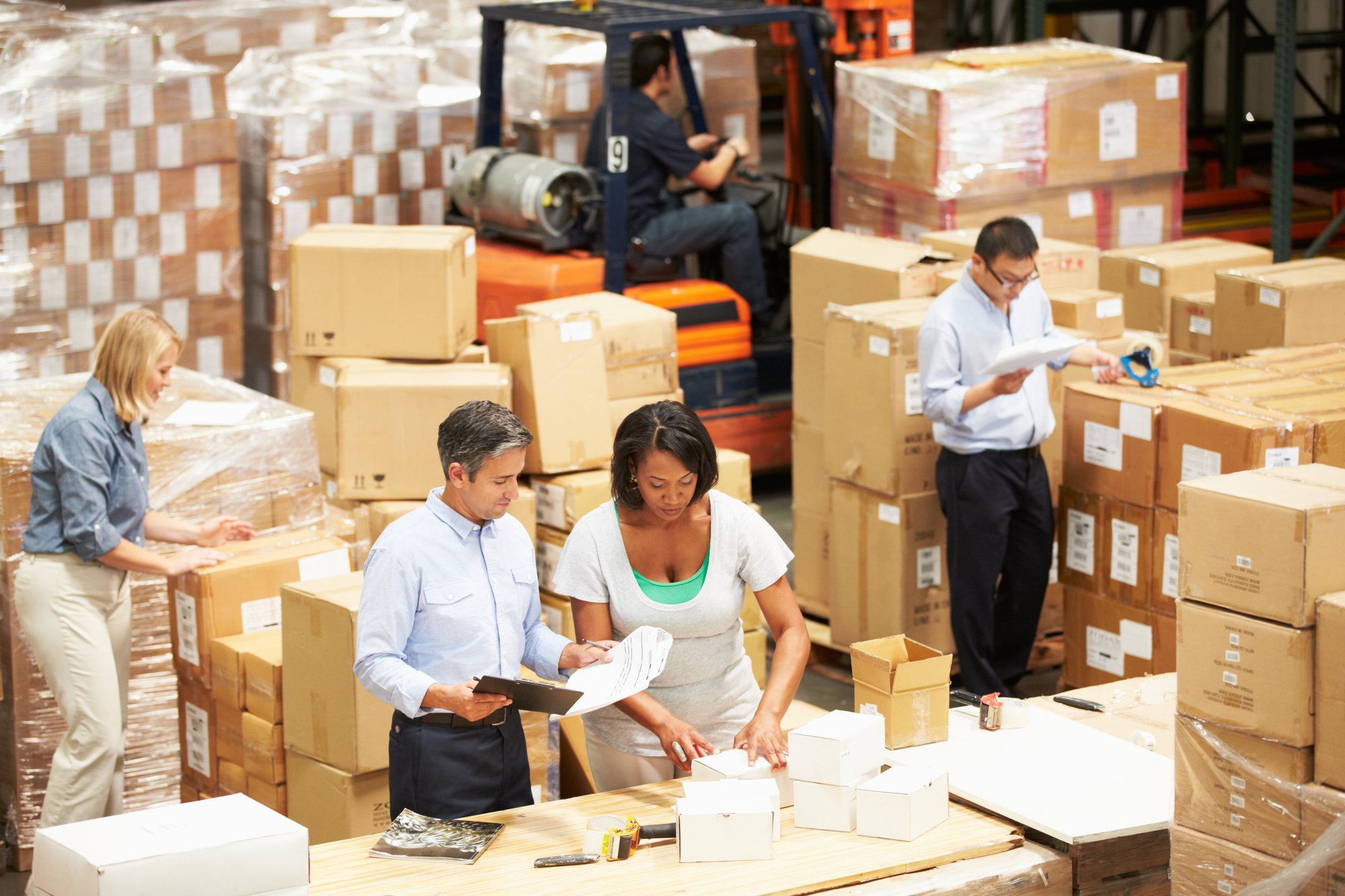 Image of workers in a warehouse evaluating boxes to symbolize GearTrack's ability to assist in tamper detection.