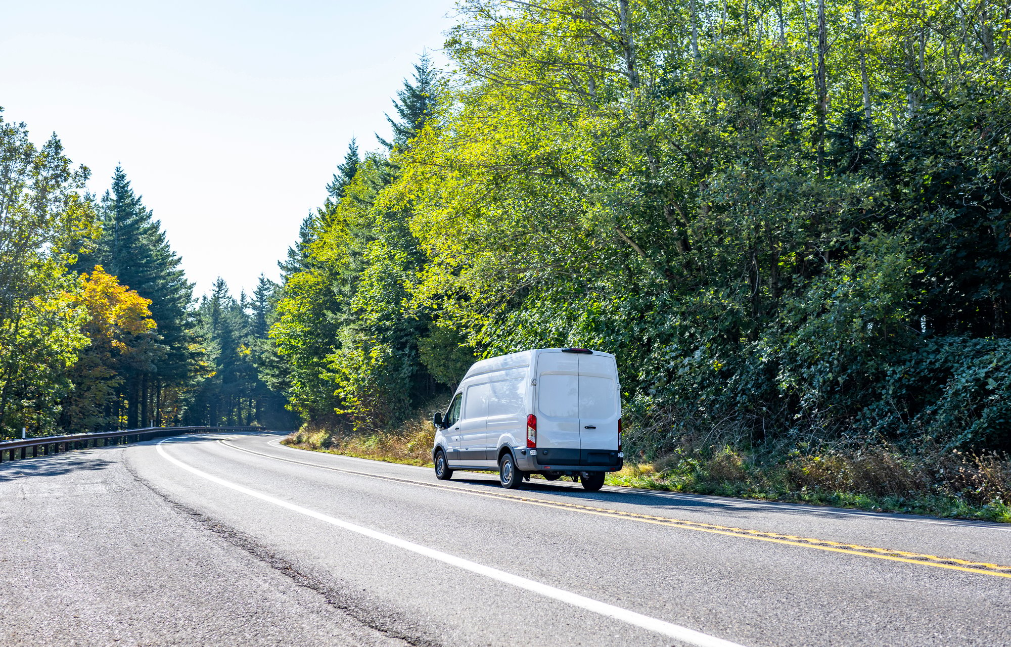 Image of a white van on a road to symbolize how Kayo provides you with real-time vehicle tracking.