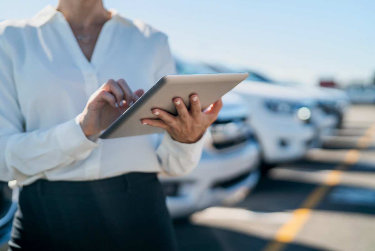 Saleswoman midsection tablet Dealerships iStock-1387193391